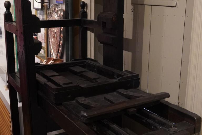 A large black printing press from the 1800's.