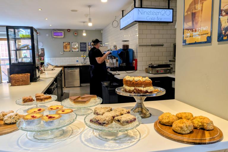 Cakes laid out on glass display stands in a cafe 