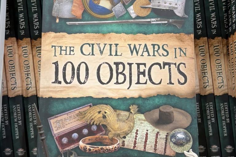 The Civil Wars in 100 Objects book on a shelve with lego figures either side. 