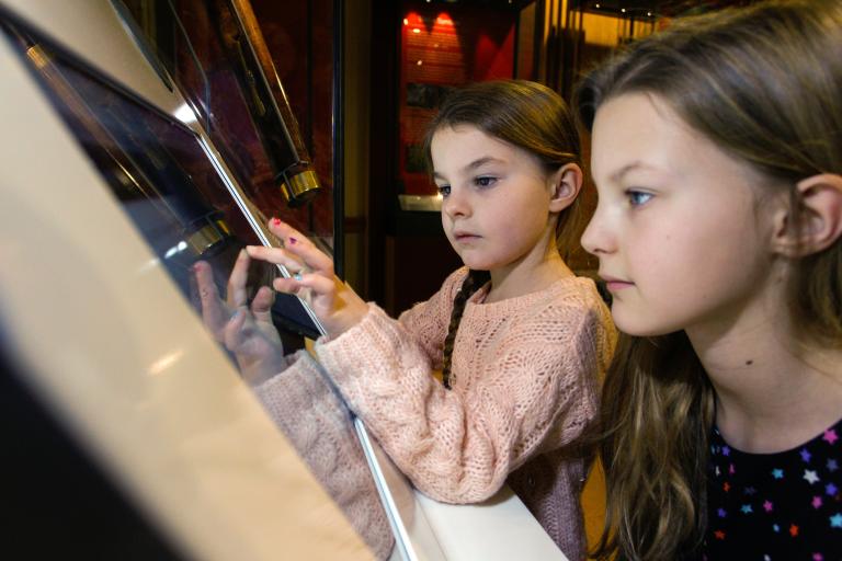 Mother and child looking at an interactive screen 