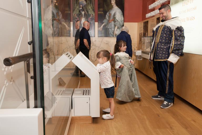 Family dressing up in civil war era clothes in a gallery space 