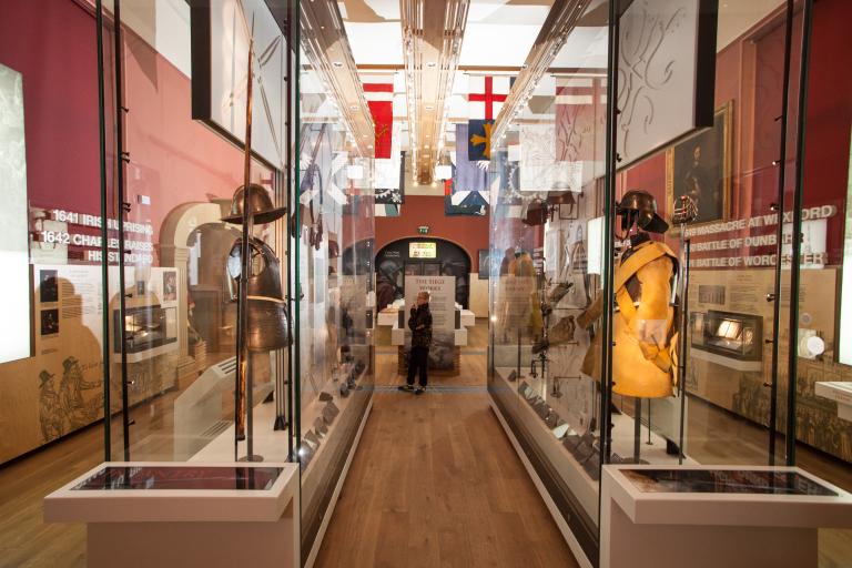 Objects, including suits of armour, in glass display cabinets in the Civil War gallery