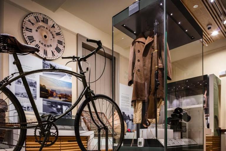 A gallery that include historial items including a bike, clock and clothes.
