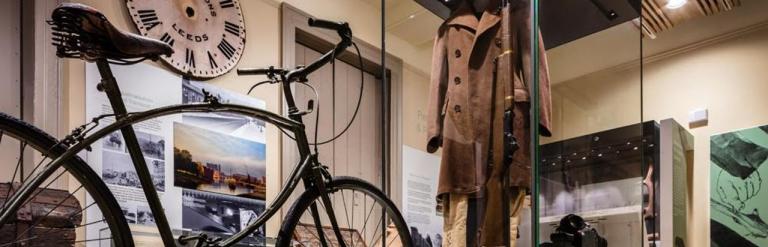 A gallery that include historial items including a bike, clock and clothes.